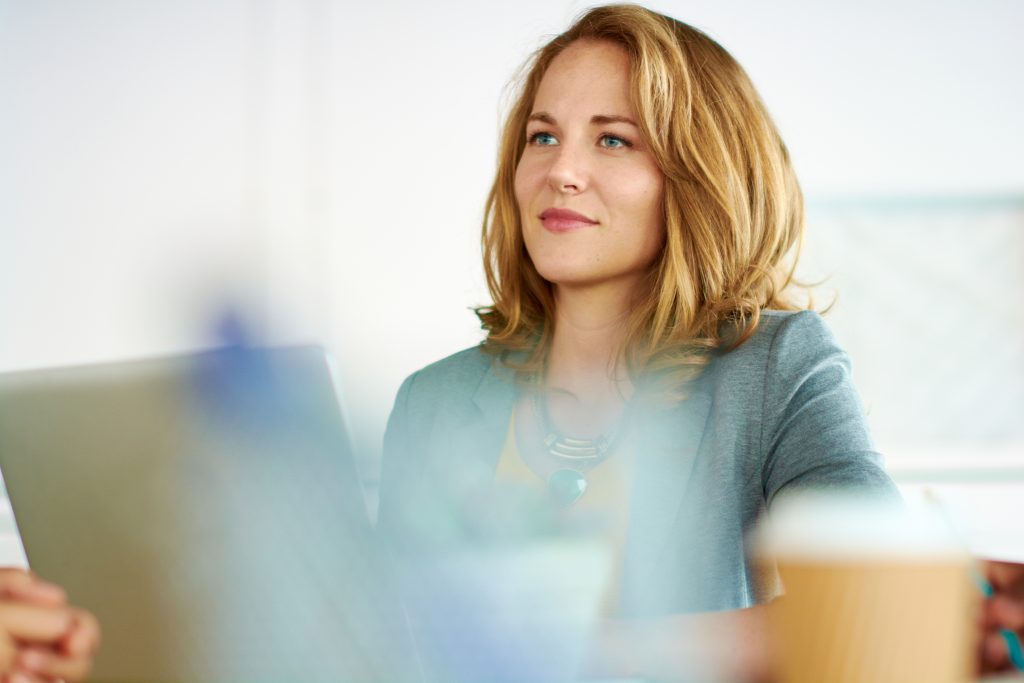Sempris Portrait of casual female employee participating in a project during a team brainstorming