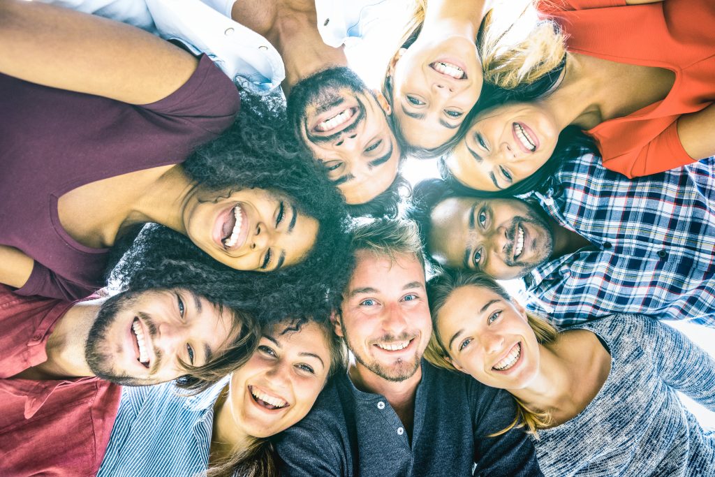 Sempris Multiracial best friends millennials taking selfie outdoors with back lighting - Happy youth friendship concept against racism with international young people having fun together - Azure filter tone