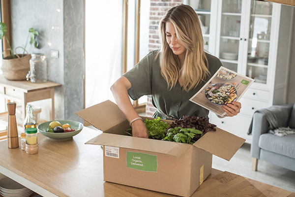 Unpacking a meal service order at the kitchen counter