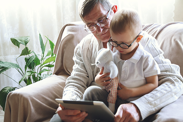 Grandfather and grandchild viewing iPad